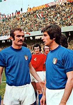 Sandro Mazzola (left) playing for Italy alongside Gianni Rivera (right); the two playmakers would be involved in manager Ferruccio Valcareggi's infamous staffetta policy at the 1970 World Cup.