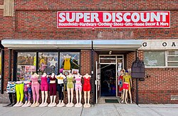 An American discount store uses a colorful display of clothing on mannequins to attract customers.