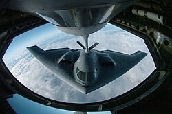 A B-2 during aerial refueling, which extends its range past 6,000 nautical miles (6,900 mi; 11,000 km) for intercontinental sorties