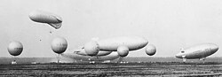 U.S. Navy airships and balloons, 1931: in the background, ZR-3, in front of it, (l to r) J-3 or 4, K-1, ZMC-2, in front of them, "Caquot" observation balloon, and in foreground free balloons used for training