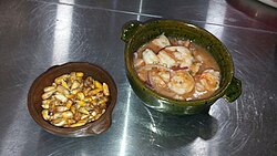 Ecuadorian ceviche, made of shrimp and lemon, onions, tomatoes and herbs. Tomato sauce, mustard and orange are used in some places, but does not form a part of the basic recipe.