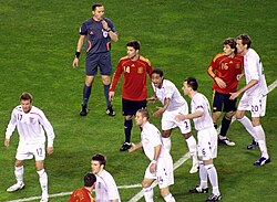 Llorente (right, number 16, marked by Peter Crouch) moments before his first goal for Spain, 11 February 2009