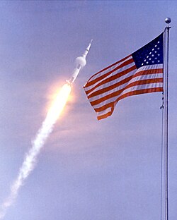 Condensation clouds surrounding the Apollo 11 Saturn V as it works its way through the dense lower atmosphere