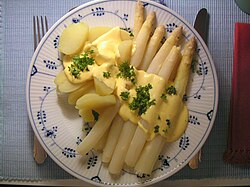 Serving of "white asparagus" with Hollandaise sauce and potatoes