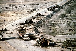 Aerial view of destroyed Iraqi T-72 tank, BMP-1 and Type 63 armored personnel carriers and trucks on Highway 8 in March 1991