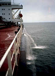 A cargo ship discharging ballast water into the sea.