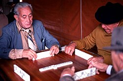 Cuban American men playing dominoes in Miami's Little Havana. In 2010, Cubans made up 34.4% of Miami's population and 6.5% of Florida's.[159][160]