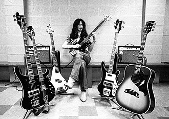 Lee on tour with various basses and an acoustic guitar