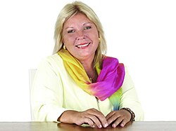 Smiling, blonde woman with multicolored scarf
