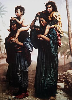 Bedouin mothers carrying their children on their shoulders. Hand-coloured print of a late 19th century black-and-white photo by French photographer Félix Bonfils.