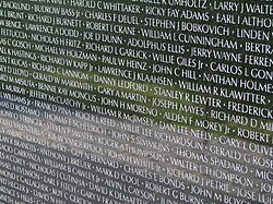 A small segment of the "Wall" at the Vietnam Veterans Memorial listing the names of the nearly 60,000 American war dead