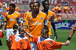Houston players walk onto the pitch with kids prior to an April 2009 match with Colorado