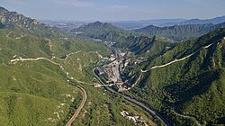 Juyong Pass, viewed from the north. The Beijing–Zhangjiakou Railway (1909) and G6 Expressway pass through this historic mountain gateway across the Great Wall north of Beijing.