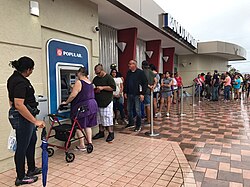 More than a week after Hurricane Maria struck, residents of Ponce, Puerto Rico wait in long lines at an ATM to withdraw cash.[172]