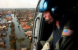 A U.S. coast guardsman searches for survivors in New Orleans in the Katrina aftermath.