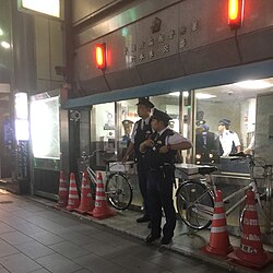 Tokyo Metropolitan Police Department officers outside a kōban (small police station) in Roppongi, Tokyo. Kōban allow police to establish a permanent police presence and offer police station services across a wide area, while taking up minimal space.