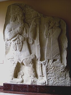A hypostasis of the Luwian weather god, “Tarḫunz of the vineyard”, as depicted on the İvriz relief.[125]