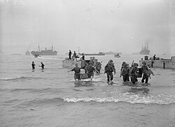 American troops unload stores from LCA 26 at Beach Z, near Arzeu