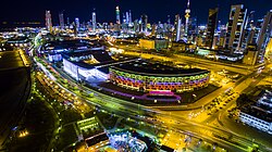Kuwait City nightscape, with the Kuwait National Assembly visible (illuminated white building in center)