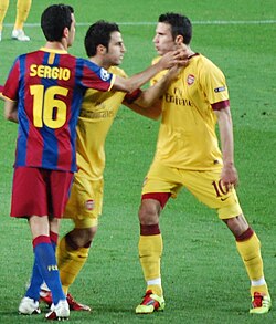 Fàbregas trying to subdue an argument between Sergio Busquets and Robin van Persie.