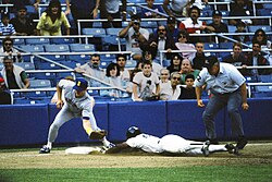 Rickey Henderson—the major leagues' all-time leader in runs and stolen bases—stealing third base in a 1988 game