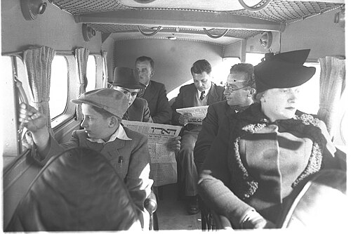 Passengers on board a Palestine Airways Short Scion, 1939. The second passenger on the left is reading Haaretz.