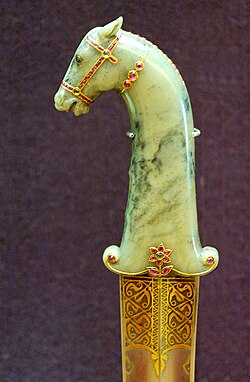 Mughal dagger with hilt in jade, gold, rubies and emeralds. Blade of damascened steel inlaid with gold.