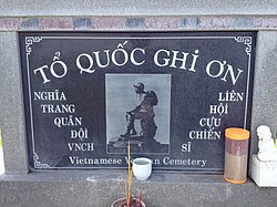 Stone plaque with photo of the Thương tiếc ("Mourning Soldier") statue, originally, installed at the Republic of Vietnam National Military Cemetery. The original statue was demolished after April 1975.