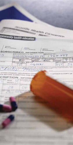 An insurance form with pills