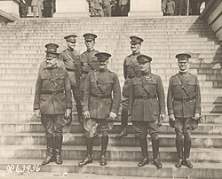General of the Armies John J. Pershing and members of his staff standing outside the State, War, and Navy Building in Washington, D.C., 23 September 1919. Stood directly behind Pershing is his aide, Colonel George C. Marshall.