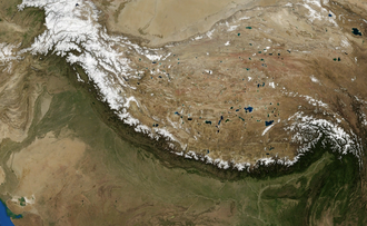 A satellite image of the Himalayas and the rainshadow effect. Development of the Himalayan front and South Asian Monsoon is thought to be driven by tectonic-climatic interactions.