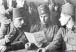 Bosnian Muslim soldiers of the SS "Handschar" reading a Nazi propaganda book, Islam und Judentum, in Nazi-occupied Southern France (Bundesarchiv, 21 June 1943)
