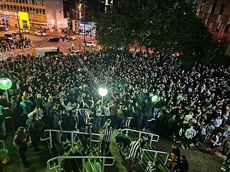 Image from 100% MAGS, showing thousands of Newcastle fans celebrating the completed takeover outside St. James' Park on 7 October 2021[138]