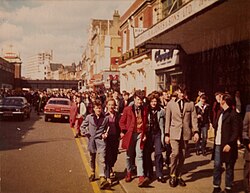 Teddy Boys walking on a busy street, 1977