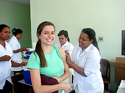 A woman receiving a vaccine by injection