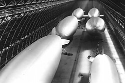 A view of six helium-filled blimps being stored in one of the two massive hangars located at NAS Santa Ana, during World War II