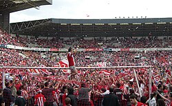 Football players celebrate with their fans the club's return to top-flight, 15 June 2008