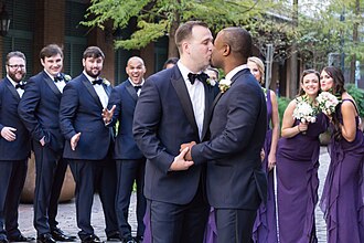 Two men marry, surrounded by wedding party, in New Orleans, United States on 11 November 2017