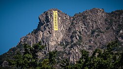 A yellow vertical protest banner which read "We demand real universal suffrage" was hung on Lion Rock during the 2014 Hong Kong protests.