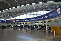 British Airways' promotional banner above the check-in desks at Heathrow Airport's Terminal 5
