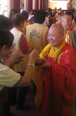 A high-ranking Bhikkhuni in the Chinese Buddhist tradition during an alms round
