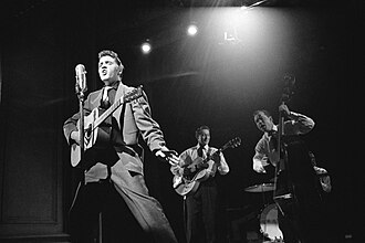 Presley performing with Scotty Moore and Bill Black in 1956
