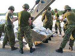Reservists of the Calgary Highlanders assist with flood mitigation work during the 2013 Alberta floods
