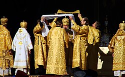 Patriarch Kirill I of Moscow washing his hands at the Great Entrance during an outdoor Divine Liturgy.