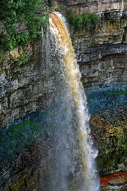 The cliff at Valaste Falls illustrates the stratigraphy of various geological eras