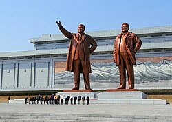 North Korean citizens paying respect to the statues of Kim Il Sung (left) and Kim Jong Il at the Mansudae Grand Monument