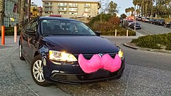 Lyft's distinctive pink mustache was the first branding the company used until 2015 when it switched to a smaller, glowing magenta mustache that sits on a driver's dashboard.