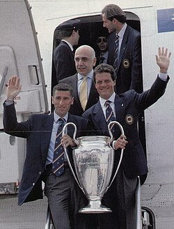 Mauro Tassotti (left) holds the UEFA Champions League trophy along with manager Fabio Capello, following Milan's victory in the 1993–94 edition of the tournament.