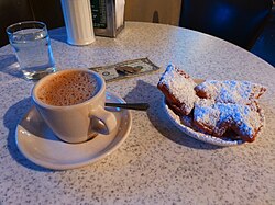 A café au lait and beignets served in Café du Monde, New Orleans