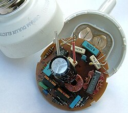 An electronic ballast and permanently attached tube in an integrated CFL